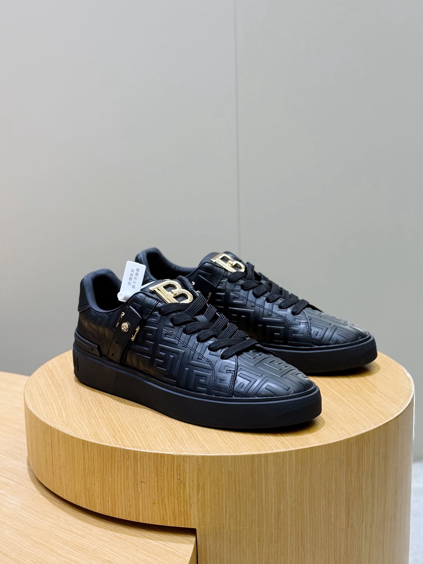 Bagsaaa Balmain black monogram-embossed leather sneakers